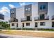 Modern townhomes featuring sleek design, balconies, and well-maintained landscaping for a contemporary urban lifestyle at 1316 W Carmen St # 2, Tampa, FL 33606