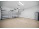 Spacious two-car garage with an epoxy floor, garage door opener, and water heater at 1316 W Carmen St # 2, Tampa, FL 33606