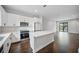 Spacious open kitchen features white cabinets, stainless steel appliances, and an island, creating a modern, functional space at 1316 W Carmen St # 2, Tampa, FL 33606