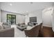 Modern living room with a sliding glass door to the exterior, contemporary furnishings, and hardwood flooring throughout at 1316 W Carmen St # 2, Tampa, FL 33606