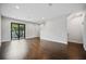 Bright and airy living room with hardwood floors, sliding glass doors, and staircase at 1316 W Carmen St # 2, Tampa, FL 33606