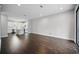 Open living space with dark floors, recessed lighting, an adjacent kitchen, and a sliding glass door to the exterior at 1316 W Carmen St # 2, Tampa, FL 33606