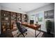Inviting home office with built-in bookshelves, a classic wooden desk, and ample natural light at 1316 W Carmen St # 2, Tampa, FL 33606