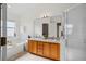 Bright bathroom with double sinks, shower, and tub under a window at 13310 Thoroughbred Loop, Largo, FL 33773