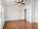 Well-lit bedroom featuring hardwood floors and a closet with doors in a move-in-ready house at 13310 Thoroughbred Loop, Largo, FL 33773