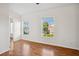 Bedroom featuring laminate flooring and multiple windows, flooding the space with natural light at 13310 Thoroughbred Loop, Largo, FL 33773