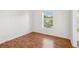 Bright bedroom with hardwood floors and a large window providing natural light at 13310 Thoroughbred Loop, Largo, FL 33773