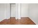 A view of an empty closet with wood-look floors in a room with white walls at 13310 Thoroughbred Loop, Largo, FL 33773