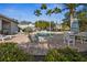 A view of the community pool with lounge chairs and palm trees on a sunny day at 13310 Thoroughbred Loop, Largo, FL 33773