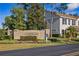 Entrance sign to the Townhomes at Cumberland Trace, set among lush landscaping and greenery at 13310 Thoroughbred Loop, Largo, FL 33773