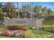 Beautifully landscaped entrance sign to the Townhomes at Cumberland Trace, with colorful flowers at 13310 Thoroughbred Loop, Largo, FL 33773