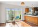 Dining area with sliding glass doors to enclosed patio and open to the kitchen at 13310 Thoroughbred Loop, Largo, FL 33773