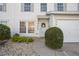 Close-up of townhouse entrance with a decorative wreath and well-kept landscaping at 13310 Thoroughbred Loop, Largo, FL 33773