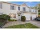 Charming two-story townhome with attached garages, tidy landscaping, and neutral color palette at 13310 Thoroughbred Loop, Largo, FL 33773