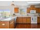 Functional kitchen with ample counter space, wood cabinets, and appliances at 13310 Thoroughbred Loop, Largo, FL 33773