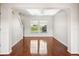 Bright living room with hardwood flooring and natural light streaming through windows at 13310 Thoroughbred Loop, Largo, FL 33773
