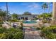 Community pool featuring lounge chairs and lush landscaping on a sunny day at 13310 Thoroughbred Loop, Largo, FL 33773