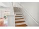 Staircase with wood treads, white risers and white banister, leading to the upper level at 13310 Thoroughbred Loop, Largo, FL 33773