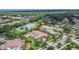 Expansive aerial view of a lovely home surrounded by verdant lawns and mature trees in a desirable location at 16406 Chapman Crossing Dr, Lithia, FL 33547