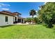 Expansive backyard with lush lawn and a patio perfect for outdoor dining and relaxation at 16406 Chapman Crossing Dr, Lithia, FL 33547