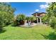 Beautiful backyard featuring a lawn, swimming pool and lush, tropical landscaping at 16406 Chapman Crossing Dr, Lithia, FL 33547