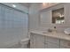 Clean, well-maintained bathroom featuring a shower, toilet, modern sink, and vanity at 16406 Chapman Crossing Dr, Lithia, FL 33547
