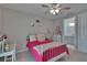Charming bedroom featuring a comfortable bed, bright decorations, and an adjacent bathroom at 16406 Chapman Crossing Dr, Lithia, FL 33547