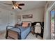 Relaxing bedroom space with balcony, ample storage, ceiling fan, and neutral decor at 16406 Chapman Crossing Dr, Lithia, FL 33547