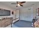 Cozy bedroom features a ceiling fan, TV, dresser, and closet with a basketball hoop at 16406 Chapman Crossing Dr, Lithia, FL 33547