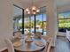 Bright breakfast nook featuring a modern chandelier and a view of the pool at 16406 Chapman Crossing Dr, Lithia, FL 33547