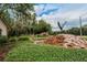 Beautifully landscaped entrance featuring a waterfall and eagle statue at 16406 Chapman Crossing Dr, Lithia, FL 33547