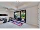Bright game room with sliding doors leading to a furnished outdoor patio with a view at 16406 Chapman Crossing Dr, Lithia, FL 33547