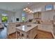 White kitchen island with stainless appliances, stone counter, and backyard view at 16406 Chapman Crossing Dr, Lithia, FL 33547