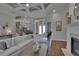 Bright living room with a white sectional, fireplace, and staircase leading to the second floor at 16406 Chapman Crossing Dr, Lithia, FL 33547