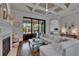 Bright and airy living room with hardwood floors, a fireplace, coffered ceiling, and sliding doors to the backyard at 16406 Chapman Crossing Dr, Lithia, FL 33547