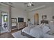 Bright main bedroom featuring hardwood floors, a ceiling fan, and an exterior door to the backyard at 16406 Chapman Crossing Dr, Lithia, FL 33547