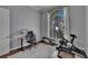 Bright home office with large window, computer desk, workout bicycle, and neutral color scheme at 16406 Chapman Crossing Dr, Lithia, FL 33547