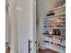 Walk in pantry with lots of shelves behind modern sliding door at 16406 Chapman Crossing Dr, Lithia, FL 33547