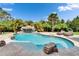 Resort-style pool with a waterfall feature and lounge chairs, perfect for relaxation at 16406 Chapman Crossing Dr, Lithia, FL 33547