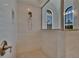 Bright walk-in shower in the main bathroom with elegant tilework and modern fixtures at 16406 Chapman Crossing Dr, Lithia, FL 33547