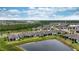 Aerial view of the home, featuring a pond view and screened lanai at 19877 Sea Glass Cir, Land O Lakes, FL 34638