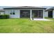 Lush backyard showcasing a screened lanai, green grass, and space for outdoor entertaining at 19877 Sea Glass Cir, Land O Lakes, FL 34638