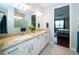 Bathroom with double vanity, granite countertops, and a view of the bedroom at 19877 Sea Glass Cir, Land O Lakes, FL 34638