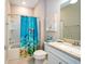 Bathroom featuring a tub/shower combination, decorated with a colorful shower curtain at 19877 Sea Glass Cir, Land O Lakes, FL 34638