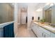 Well-lit bathroom with a double sink vanity, granite countertops, and a glass-enclosed shower at 19877 Sea Glass Cir, Land O Lakes, FL 34638