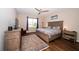Bedroom with hardwood floors, ceiling fan, and wooden furniture with blue accents at 19877 Sea Glass Cir, Land O Lakes, FL 34638