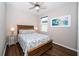 Relaxing bedroom with wood floors, decorative headboard, ceiling fan, and bright natural lighting at 19877 Sea Glass Cir, Land O Lakes, FL 34638