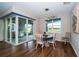Bright dining area with sliding glass doors leading to an enclosed patio with a grill at 19877 Sea Glass Cir, Land O Lakes, FL 34638