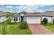 Beautiful single-story home with a two-car garage and a well-manicured front yard at 19877 Sea Glass Cir, Land O Lakes, FL 34638