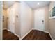 A bright foyer with wood flooring and neutral paint, leading to other rooms in the house and a coat closet at 19877 Sea Glass Cir, Land O Lakes, FL 34638